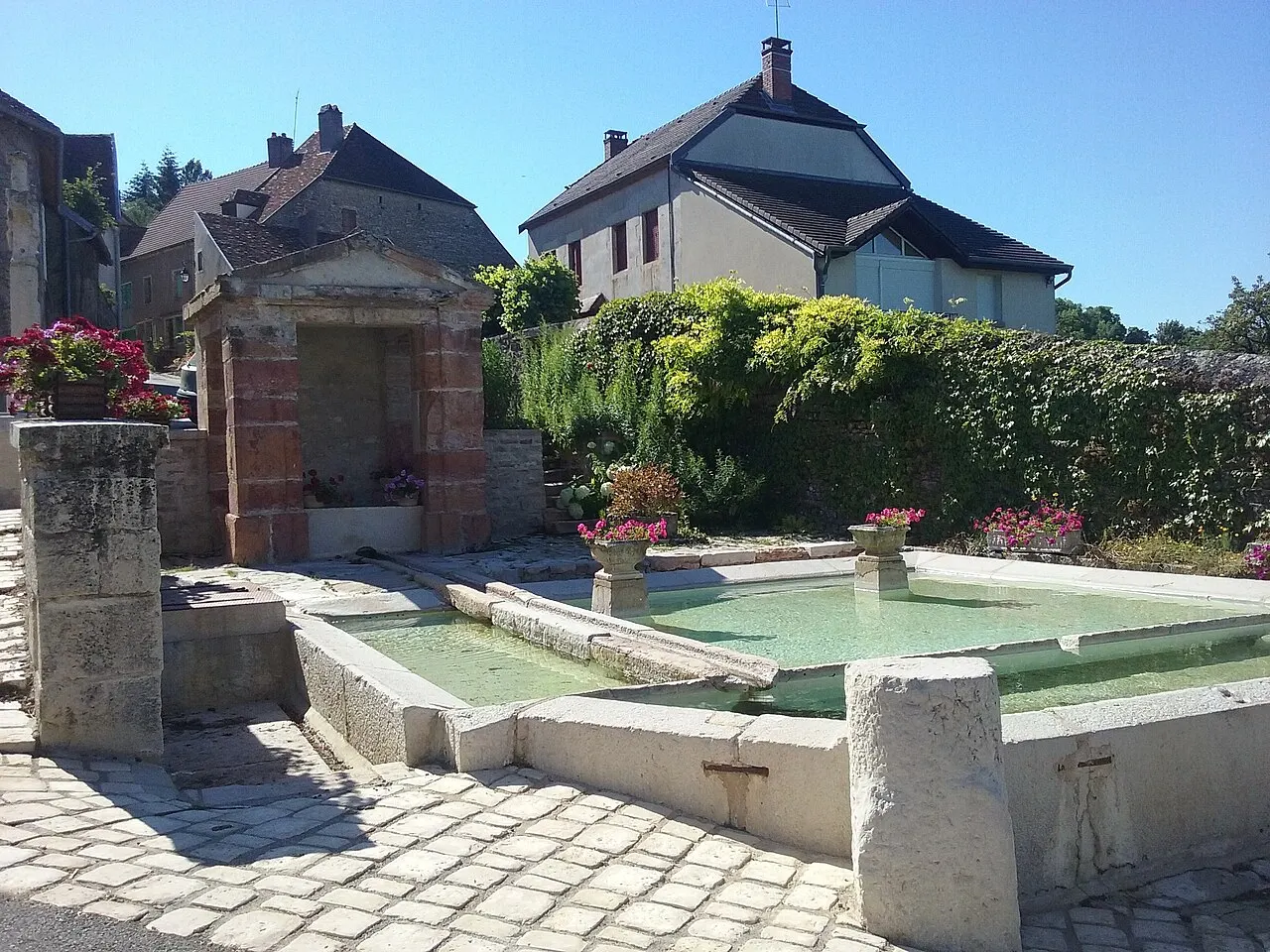 Ensemble formé par la fontaine, le lavoir et la croix, au Nord du village
